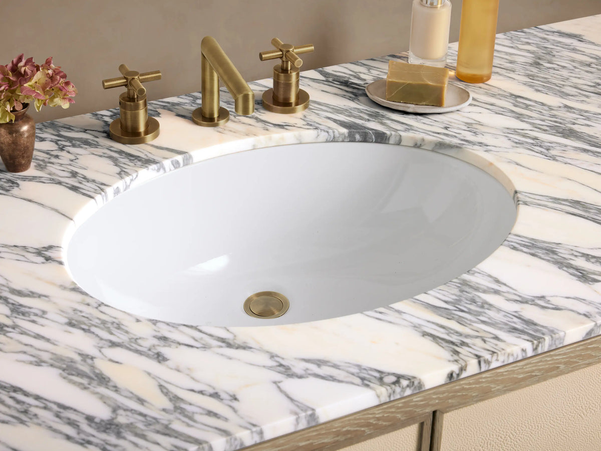 Malone Wide Single Vanity. Light oak vanity with veined marble top, single sink, 2 textured beige doors, 6 textured beige drawers.