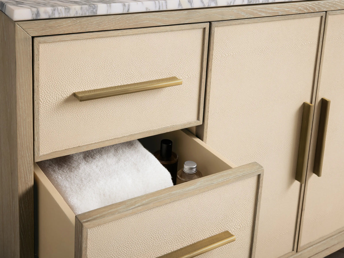 Close-up of Malone Wide Single Vanity's white oval undermount sink in a white and grey veined Arabescato marble countertop.