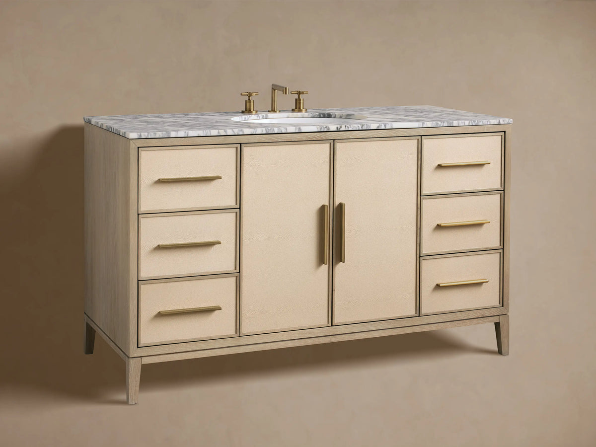 Close-up of Malone Wide Single Vanity with open cabinet door, showcasing cream shagreen texture, brass handle, and interior shelves with towels.