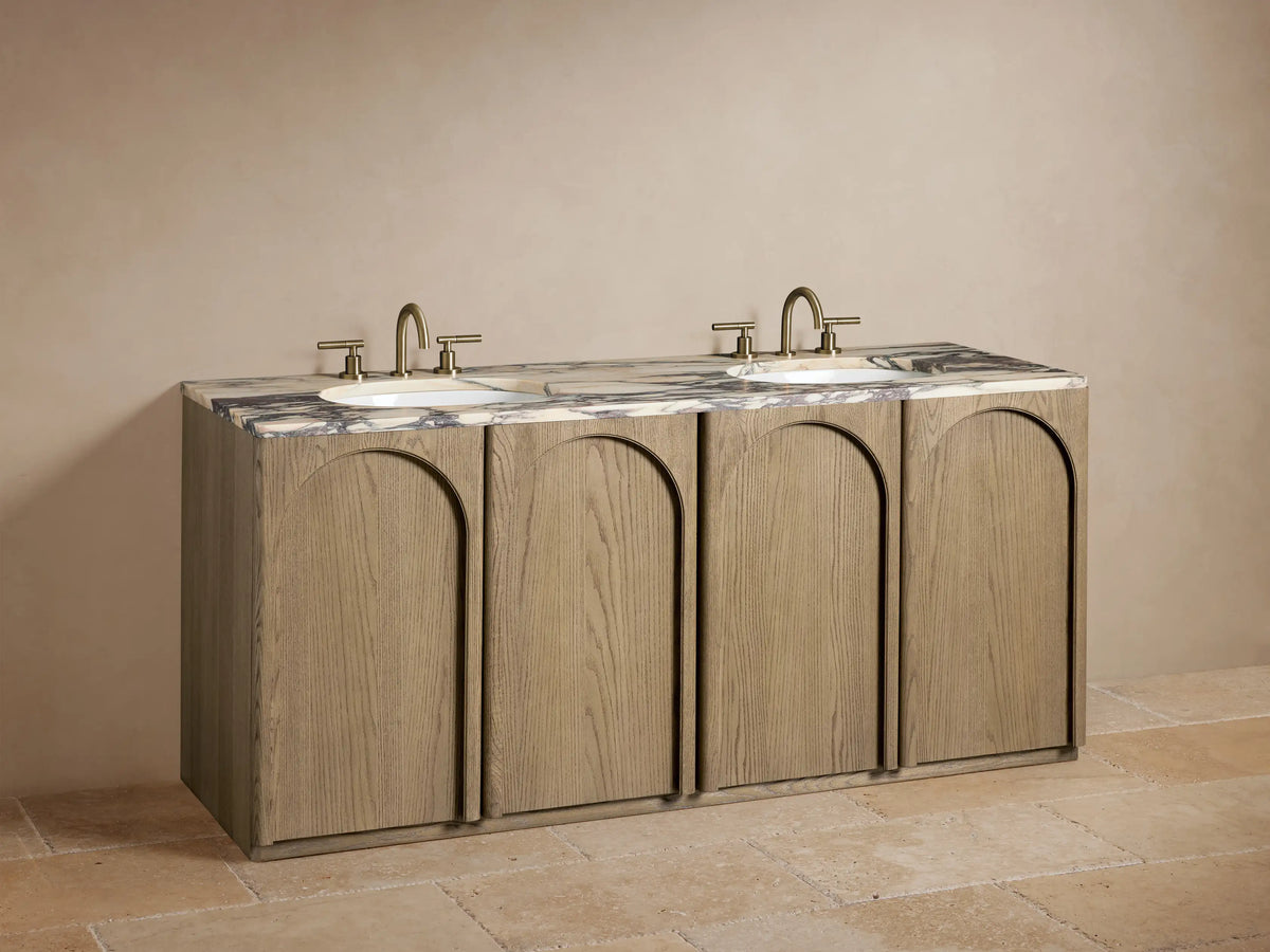 Open cabinet of Provo Double Vanity in oak wood, showing interior shelves with folded white towels, a cylindrical container, and a small bottle.
