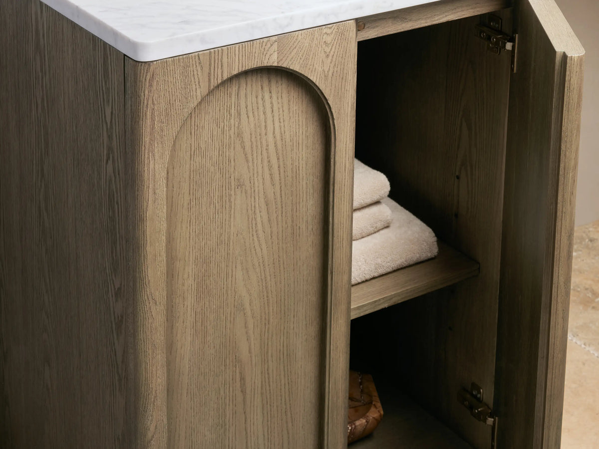 Provo Powder Vanity with a marble stone top featuring an oval ceramic undermount sink, gold faucet, and accessories on the countertop.