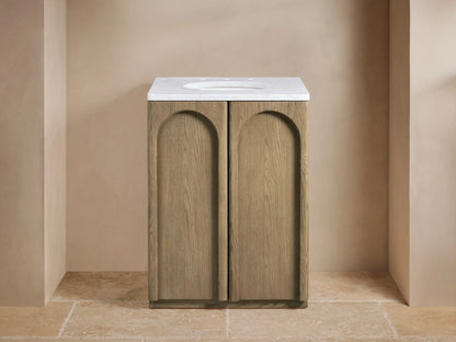 Provo Powder Vanity with oak wood finish, open door revealing shelves with towels, stone top visible.