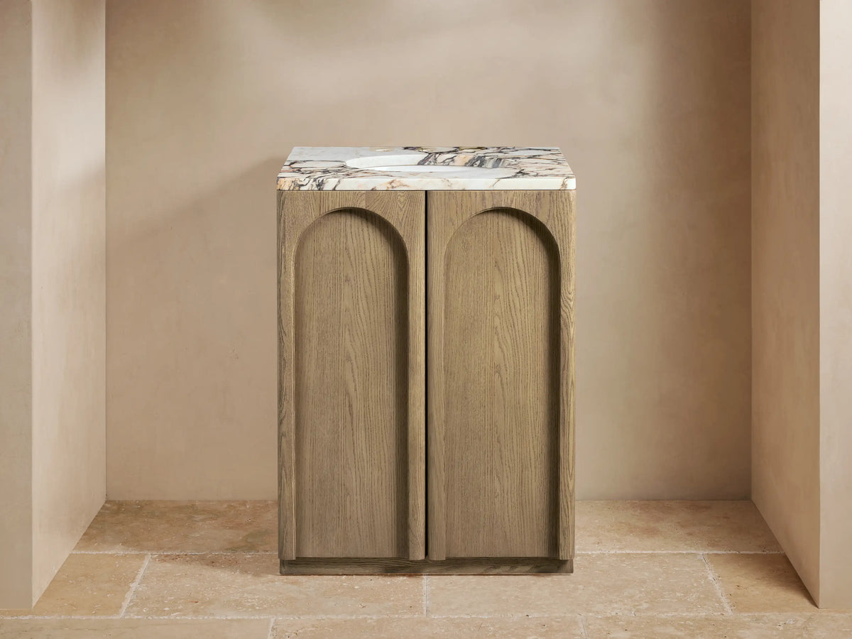 Provo Powder Vanity with open soft-close oak door, revealing shelves with folded towels. Marble top shows veining detail.