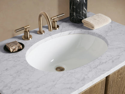Light oak Provo Single Vanity with two arched doors, white marble top, oval sink, against a pale wall & tiled floor.
