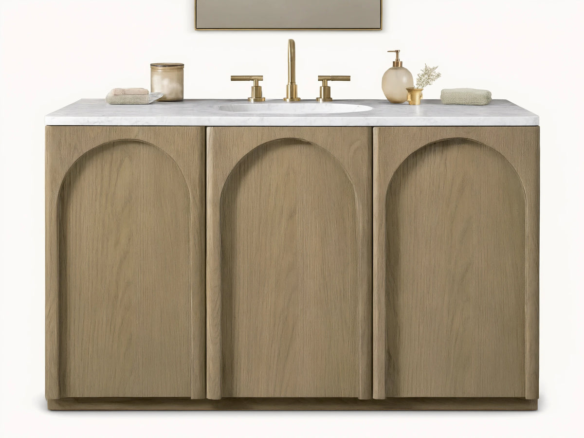 Provo Single Wide Vanity with oak wood doors and stone top, featuring an oval sink and brass faucets, in a neutral-toned bathroom.