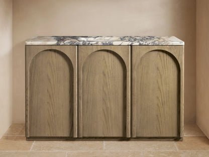 The Provo Single Wide Vanity features three oak wood panels, a marble top with veining, and a double faucet setup.