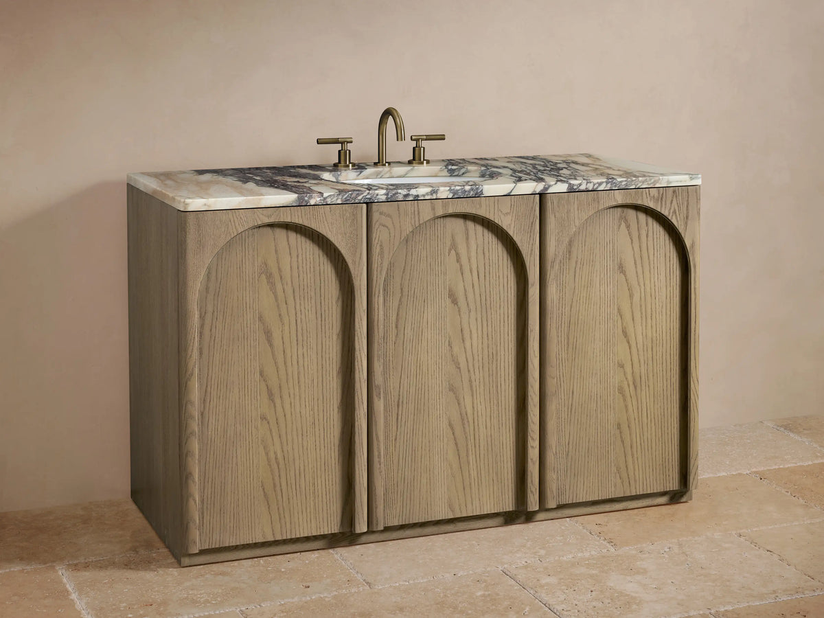 Provo Single Wide Vanity with open soft-close oak cabinet door, showing shelves storing towels and toiletries, topped with veined marble.