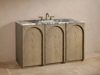 Provo Single Wide Vanity with open soft-close oak cabinet door, showing shelves storing towels and toiletries, topped with veined marble.