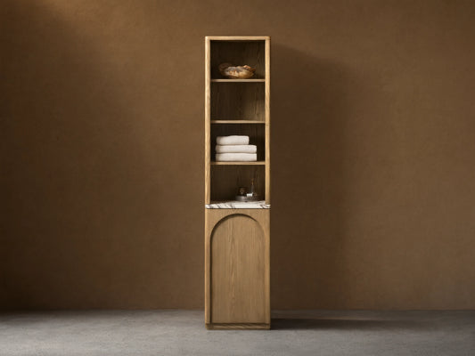 Tall, narrow Provo Etagere with oak wood frame, featuring shelves with towels and items. Marble stone top and closed cabinet below.