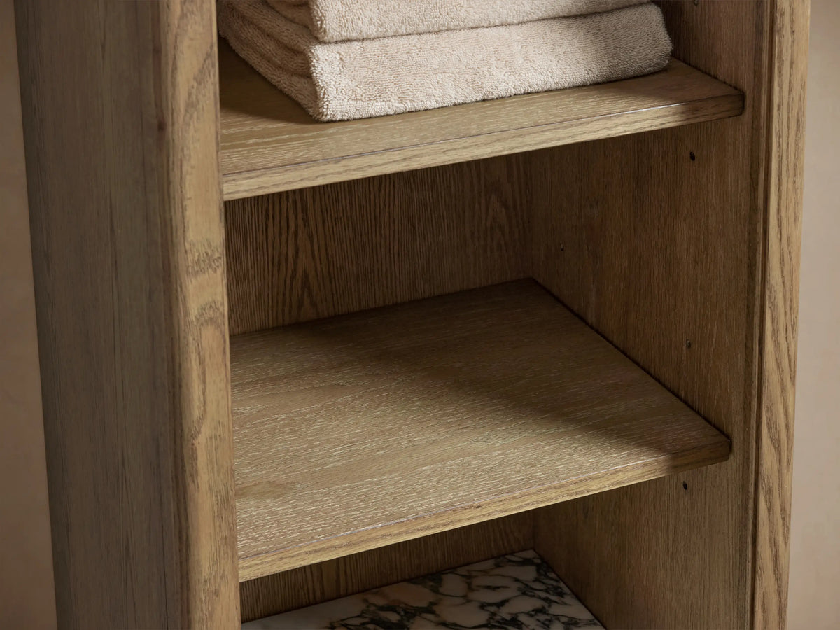 The Provo Etagere features a marble stone top with distinct veining on a wooden shelf, holding two folded towels and decorative items.