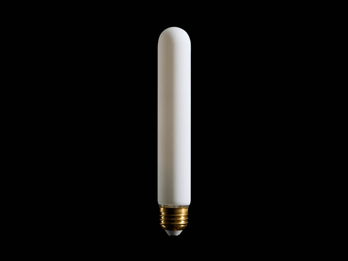 A long, cylindrical white light bulb with a smooth surface, featuring a gold screw base, standing vertically against a black background.