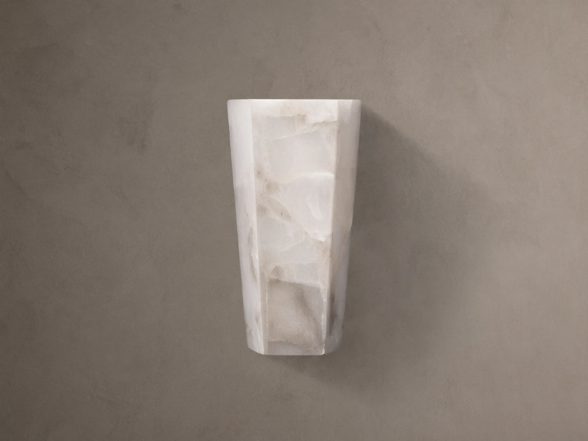 Alabaster Hexagonal Sconce. Vertical, off-white with natural cream and beige veining, on a neutral taupe wall.