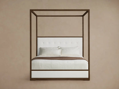 Front view of the Darien Box-Tufted Canopy Bed with dark wood frame, white box-tufted headboard, and white upholstered footboard.