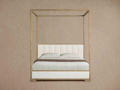 Darien Channel-Stitched Canopy Bed. Light oak frame, white channel-stitched headboard & base, light beige bedding with brown throw.