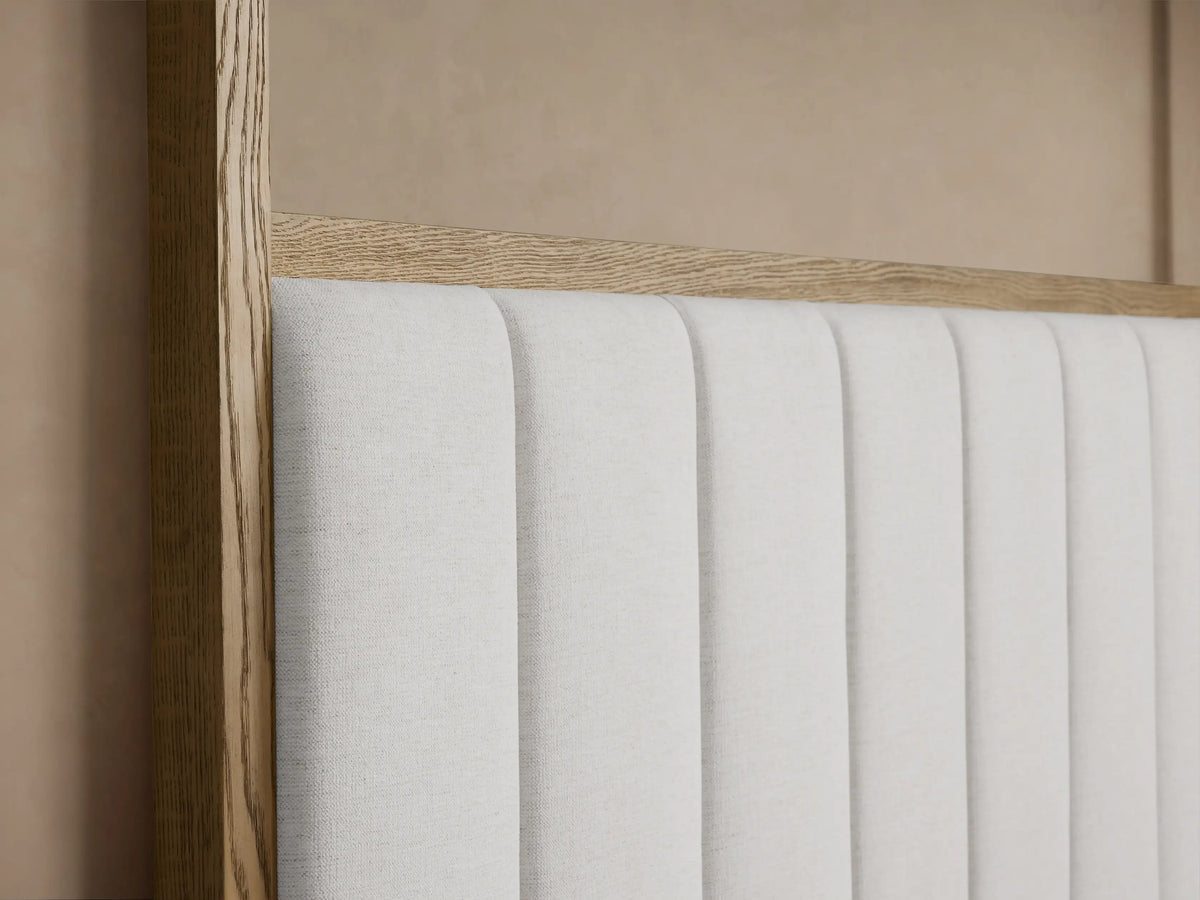 Darien Channel-Stitched Canopy Bed: Light oak frame, white channel-stitched headboard, white bedding, brown throw.