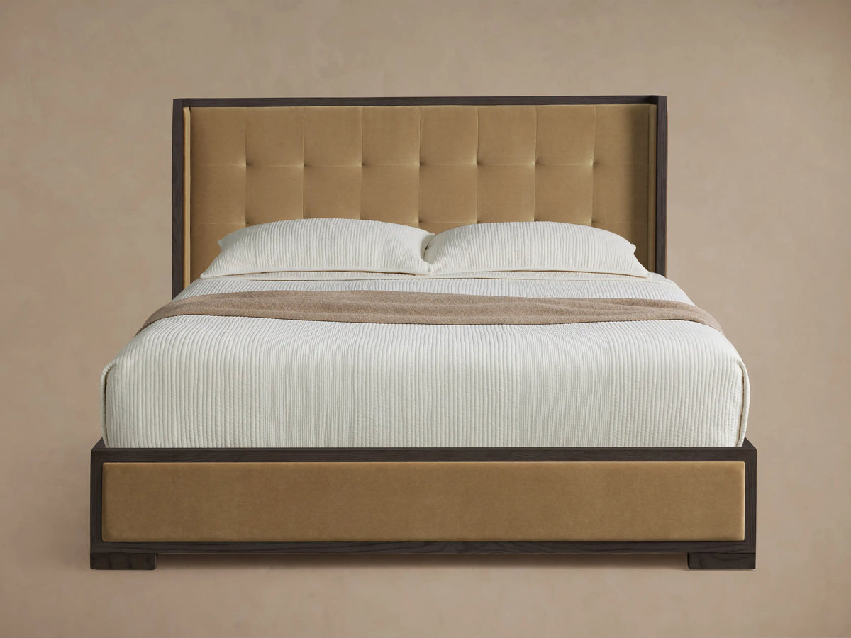 Darien Box-Tufted Shelter Bed: Dark wood frame, tan box-tufted headboard and side panels, with white bedding and a beige throw.