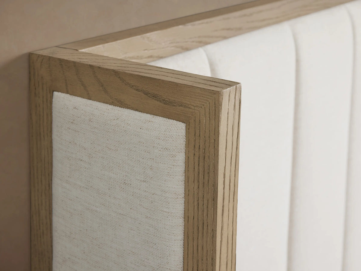 Darien Channel-Stitched Shelter Bed with light wood frame, white channel-stitched headboard, white bedding, and gray throw.
