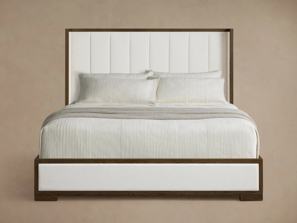 Front view of the white upholstered Darien Channel-Stitched Shelter Bed with a channel-stitched headboard and dark oak wood frame.