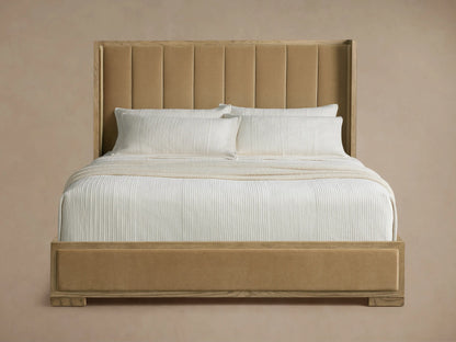 Darien Channel-Stitched Shelter Bed with beige upholstered, channel-stitched headboard, light oak frame, white bedding.