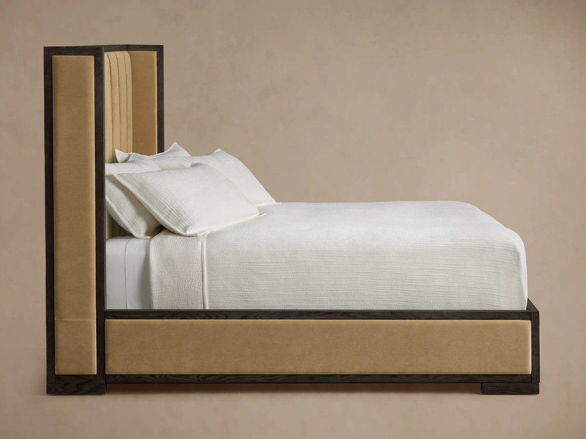 Close-up of Darien Channel-Stitched Shelter Bed headboard, featuring dark brown oak frame and tan channel-stitched upholstery.