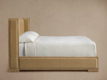 Close-up of Darien Channel-Stitched Shelter Bed's light oak headboard corner with vertical beige upholstered panels.