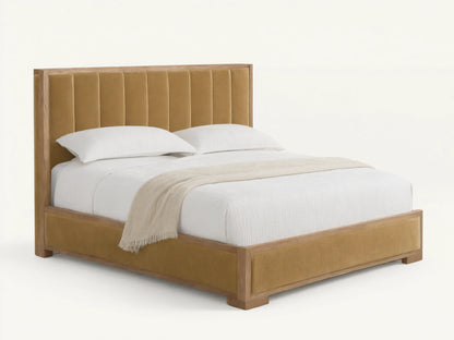 Darien Channel-Stitched Shelter Bed with tan upholstered headboard & footboard, light oak frame, white textured bedding on wood floor.