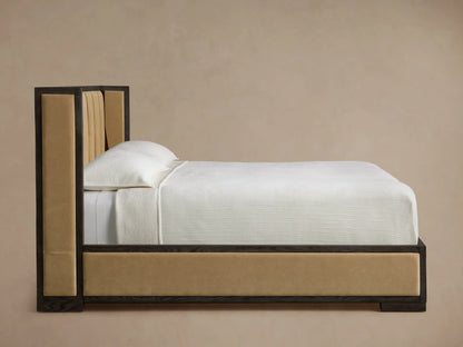 Close-up of Darien Channel-Stitched Shelter Bed headboard corner. Dark oak frame with beige channel-stitched upholstered panels.