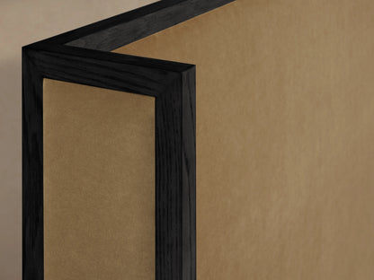 Alt text: Close-up view of the Darien Shelter Bed's high footboard, featuring dark oak veneer framing with upholstered tan panels.