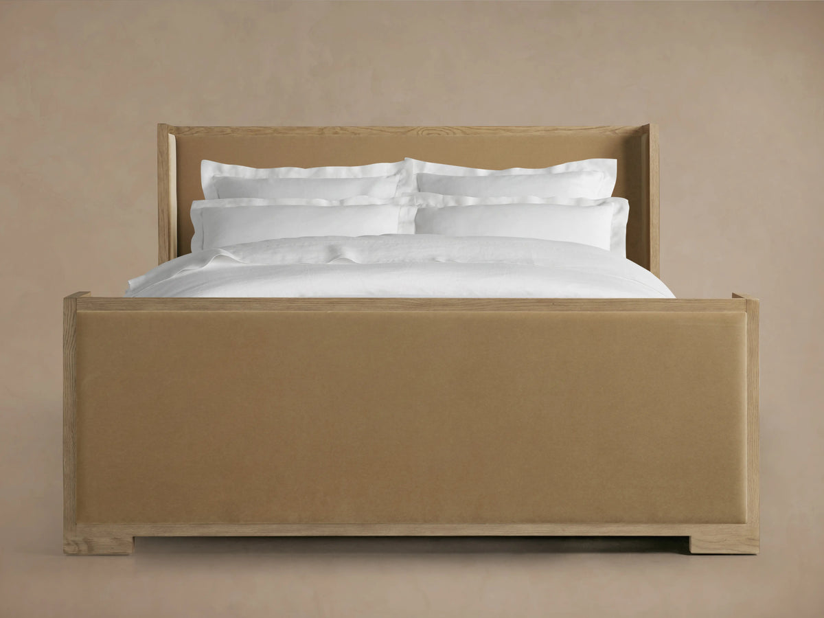 Alt text: Close-up of the Darien Shelter Bed's high footboard, showcasing oak veneer and solid oak wood frame with a beige upholstered panel.