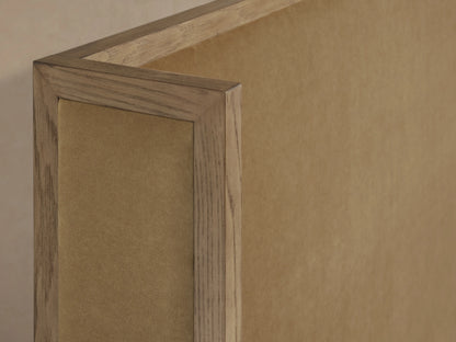 Close-up view of the Darien Shelter Bed's high footboard, featuring oak veneer and solid oak wood with a hand-applied finish.