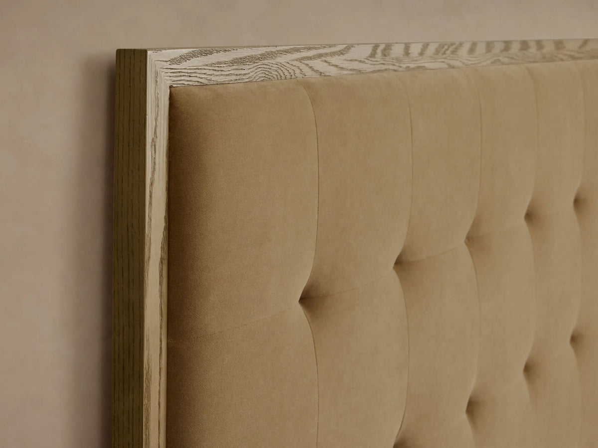 Darien Box-Tufted Panel Bed: Natural oak frame with warm tan upholstered panels, box-tufted headboard. White bedding.