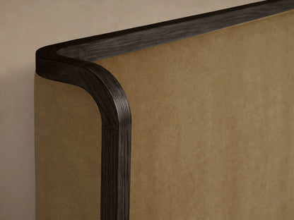 Darien Curved Shelter Bed with high footboard, brown oak frame, beige upholstered panels, white bedding, front view.