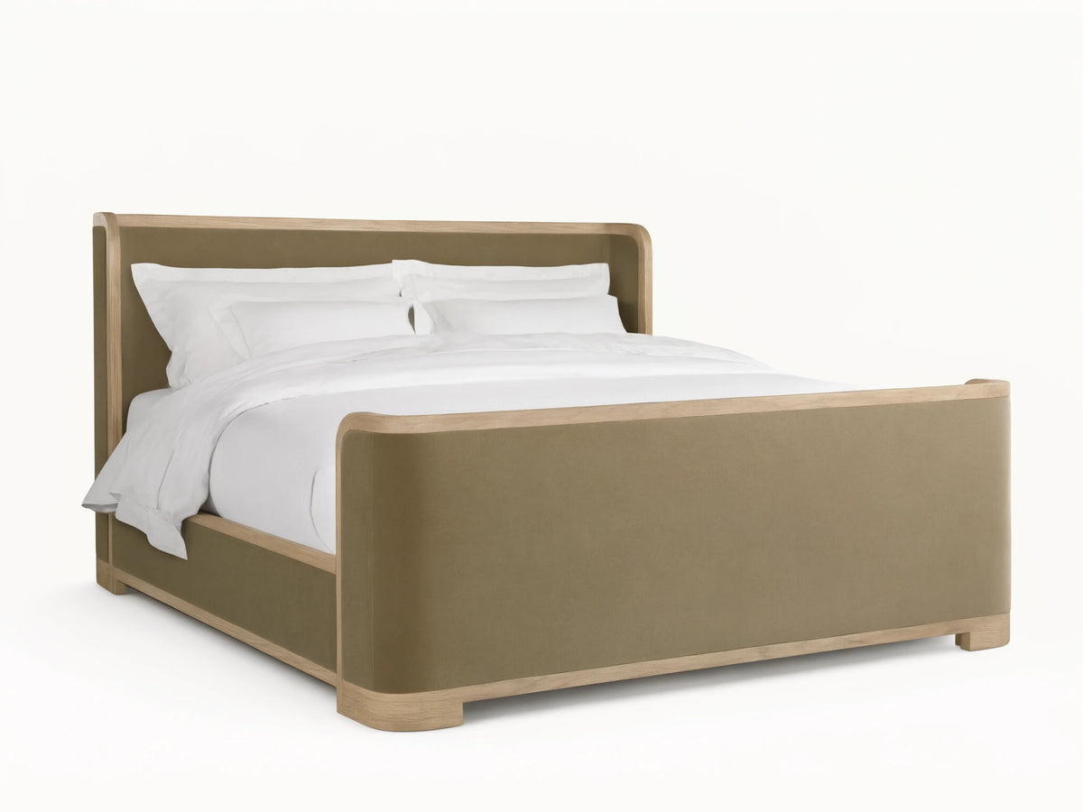 Darien Curved Shelter Bed in oak with high footboard, beige upholstered panels, white bedding, on wooden floor, side view.
