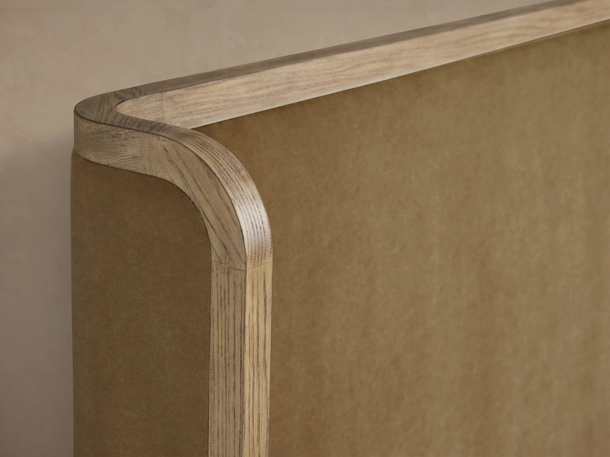 Darien Curved Shelter Bed with high footboard, oak veneer frame, upholstered panels, white bedding, wood finish.