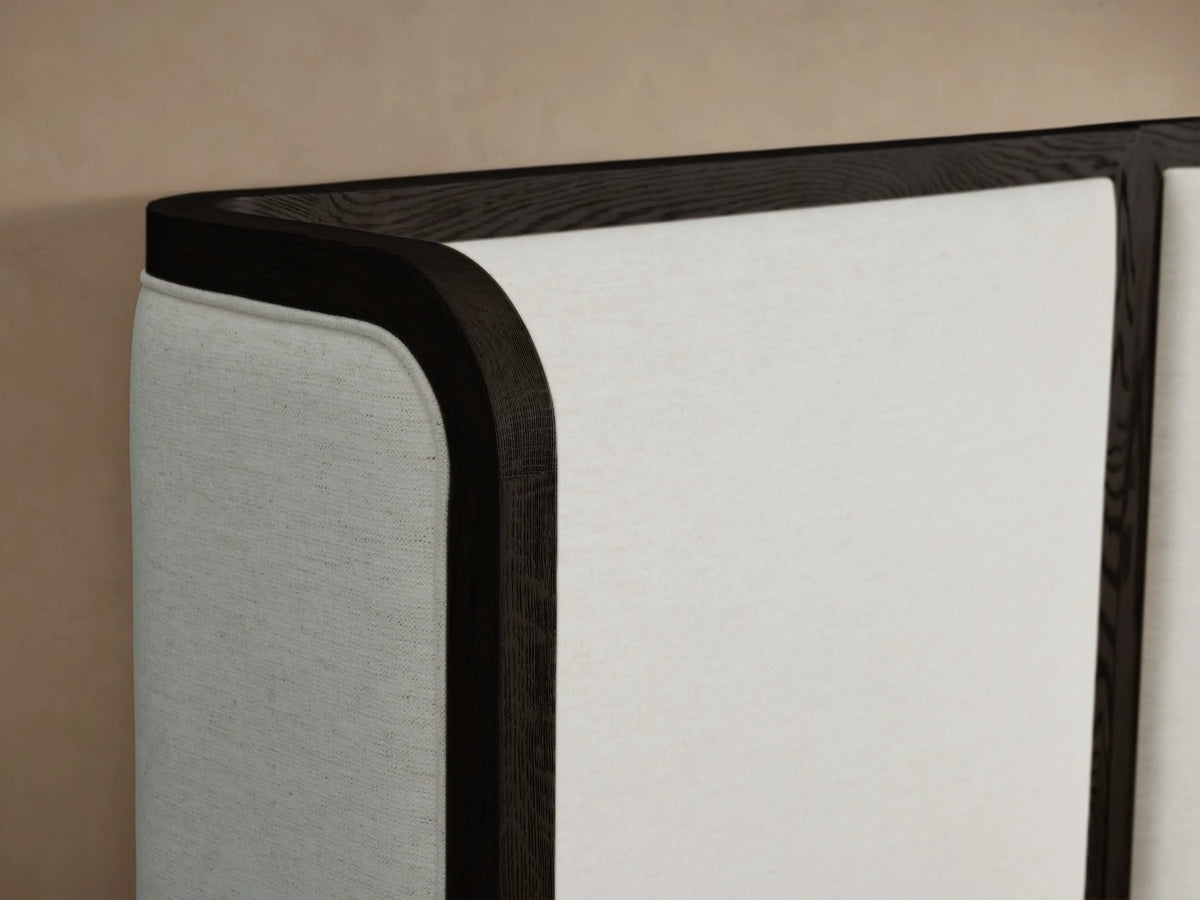 Darien Extended Curved Shelter Bed, white upholstered panels with dark wood frame & curved ends, white textured bedding, beige wall.