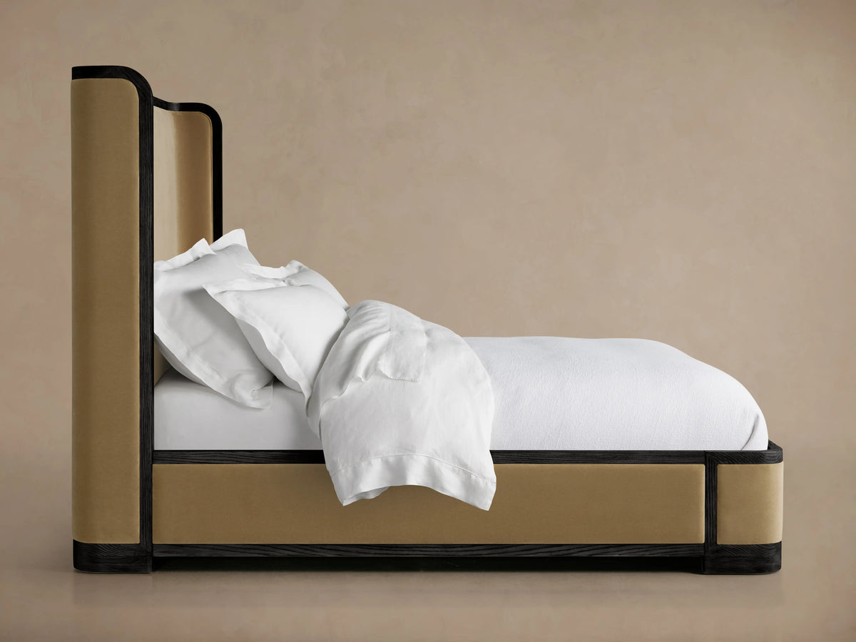 Darien Curved Shelter Bed's corner detail, featuring oak veneer and solid oak wood with dark hand-applied finish and beige upholstered panel.