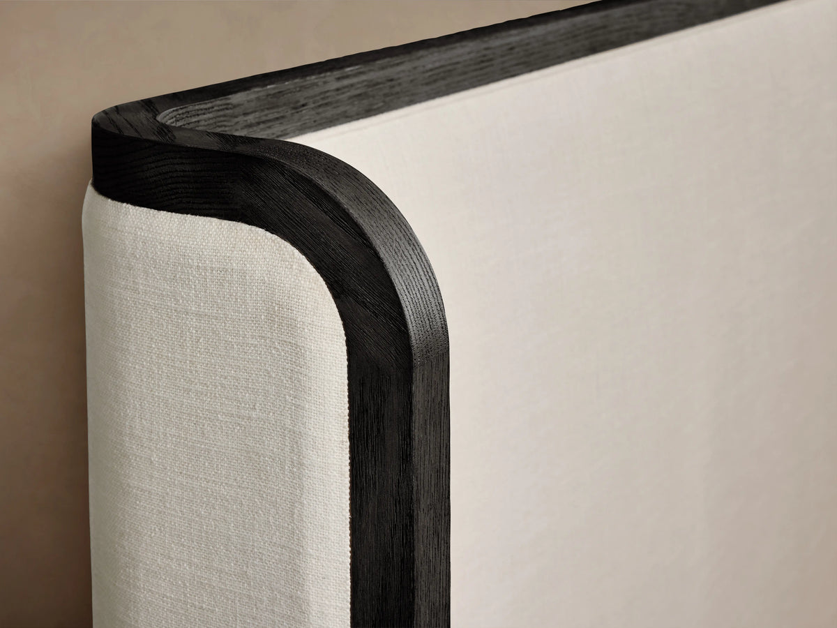 Darien Curved Shelter Bed with low footboard, oak frame, upholstered panels, white bedding, and a curved headboard.