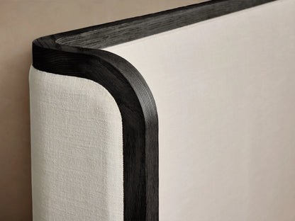 Darien Curved Shelter Bed with low footboard, oak frame, upholstered panels, white bedding, and a curved headboard.