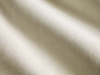 Darien Curved Shelter Bed, side view. Cream upholstered panels within a dark wood frame, made with white bedding.