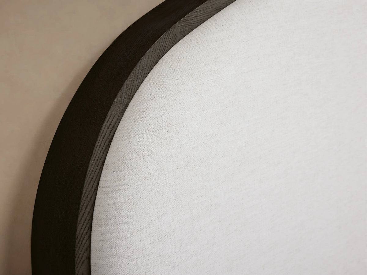 Danny Bed with arched white fabric headboard, dark oak frame, white textured bedding, and a grey throw blanket.