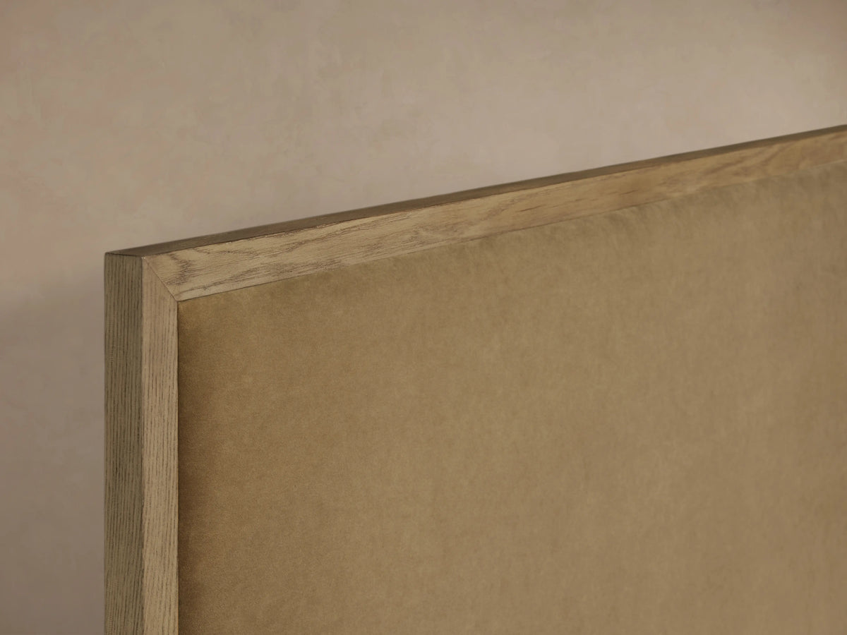 Darien Panel Bed high footboard showing oak veneer frame and upholstered panel with light brown finish.
