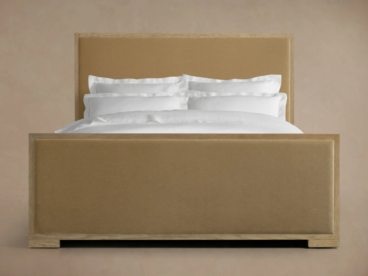 Darien Panel Bed with High Footboard, featuring oak veneer frame, brown upholstered panels, white bedding, headboard and footboard visible.