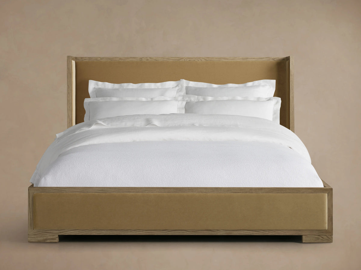 Darien Shelter Bed with Low Footboard in neutral finish, features oak veneer, upholstered panels, and white bedding in a beige room.