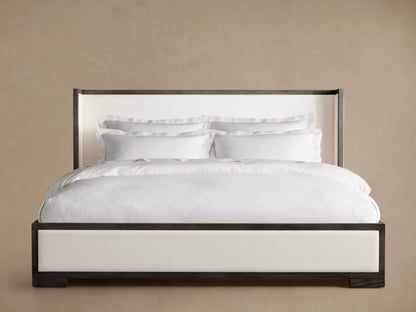 Darien Shelter Bed featuring a low footboard, light upholstered panels, contrasting oak frame, and crisp white bedding.