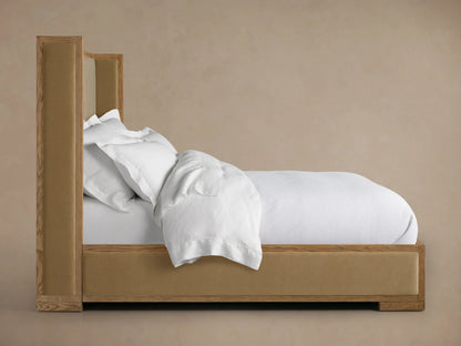 Darien Shelter Bed with Low Footboard featuring oak wood frame, upholstered panels, and white bedding, against a beige backdrop.