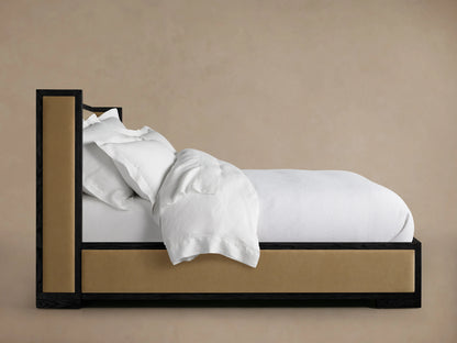 Darien Shelter Bed with Low Footboard, featuring an oak frame and upholstered panels in profile view, dressed with white bedding.