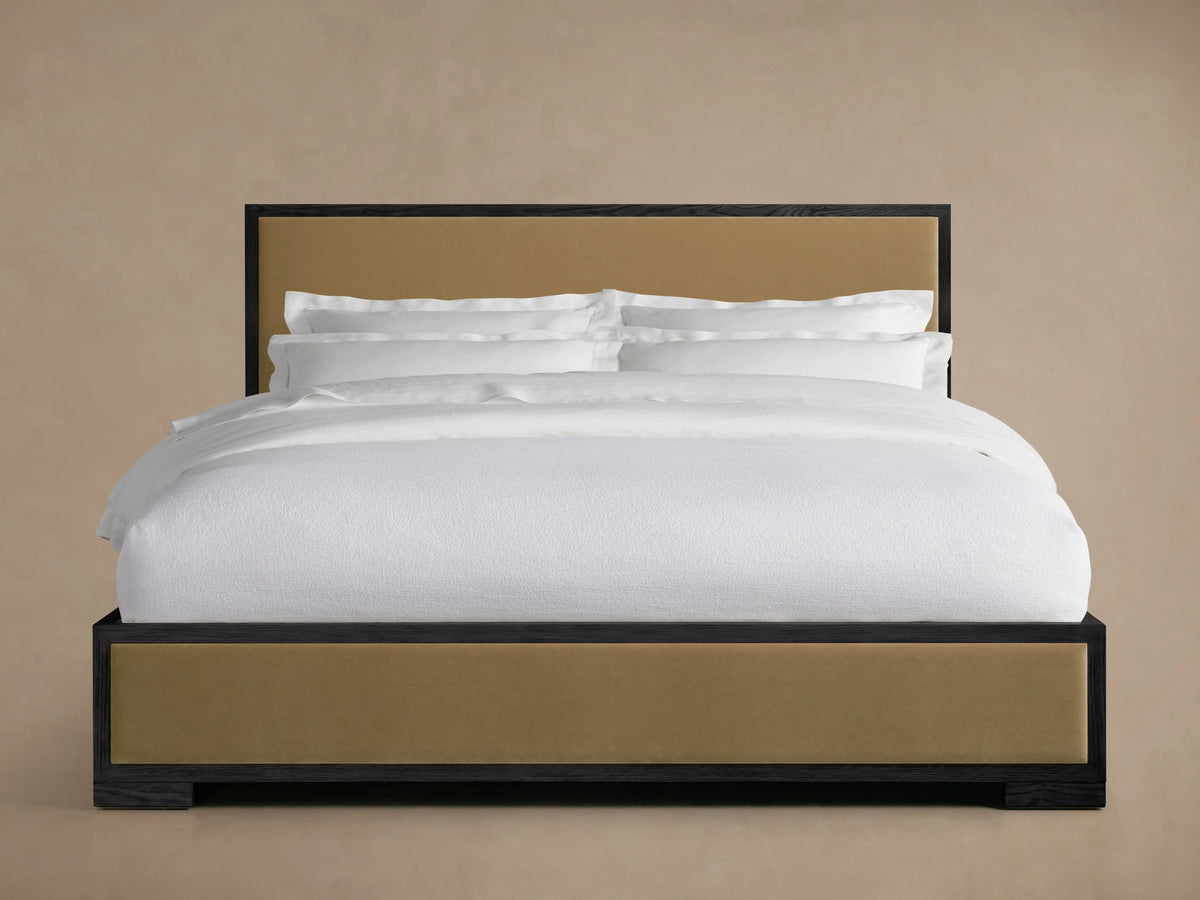 Darien Panel Bed with oak frame, upholstered tan panels, and low footboard; white bedding displayed in front view.