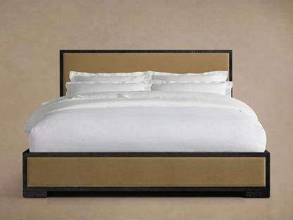 Darien Panel Bed with oak frame, upholstered tan panels, and low footboard; white bedding displayed in front view.