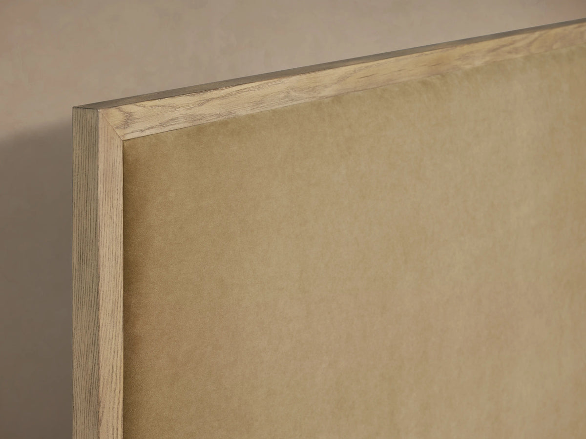 Edge of Darien Panel Bed headboard with oak veneer frame and beige upholstered panel, light wood finish.