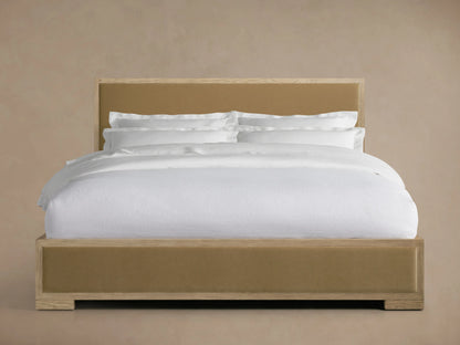 Darien Panel Bed with Low Footboard in oak, featuring a beige upholstered headboard and footboard, shown with white bedding.